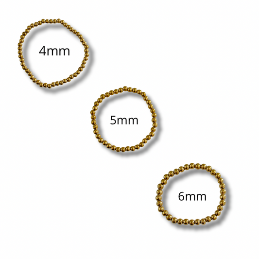 Pulseras bolitas - elásticas - dorado